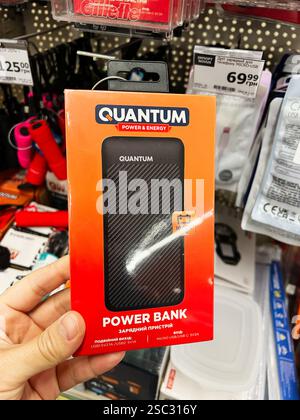 Kyiv, Ukraine - February 04, 2025: Compact power bank in retail package, displayed in a store with various electronics. Stock Photo