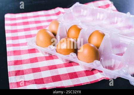 Eggs on tablecloth over black background Stock Photo