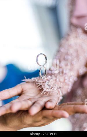 Ring flying over hands. coupled hands, groom and bride and wedding rings Stock Photo