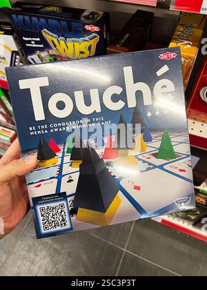 Kyiv, Ukraine - February 04, 2025: An image featuring the box of Touche strategic board game with colorful components displayed. Stock Photo