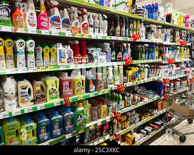 Kyiv, Ukraine - February 04, 2025: Shelves stocked with diverse colorful cleaning supplies in a bright supermarket. Stock Photo