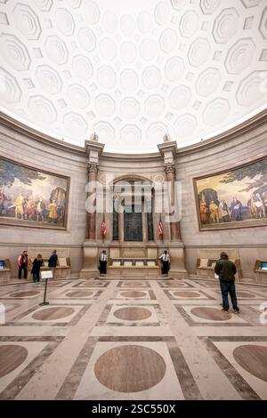 WASHINGTON DC — The National Archives Rotunda houses America's founding documents: the Declaration of Independence, Constitution, and Bill of Rights, collectively known as the Charters of Freedom. Two massive murals by Barry Faulkner depicting the presentation of the Declaration of Independence and the Constitution overlook these foundational documents of American democracy. Stock Photo