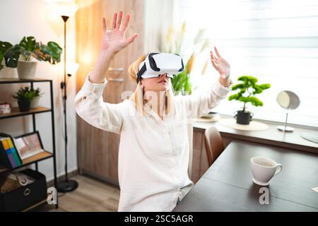 Exploring virtual realities in a cozy home environment with immersive technology Stock Photo