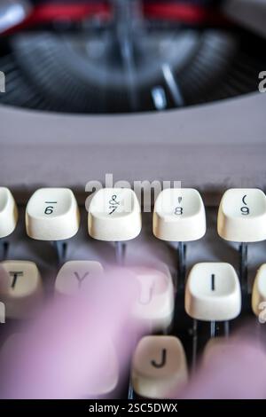 Detail of someone typing on an old manual typewriter Stock Photo