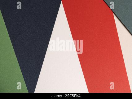 Modern geometric paper composition with bold contrasting colors, including green, navy blue, red, and off-white, layered with textured surfaces, creat Stock Photo