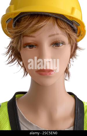 Horizontal close-up shot of a female mannequin in construction clothes with yellow hard hat. Stock Photo