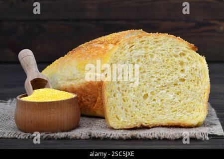 Cornbread and corn flour on wooden background Stock Photo
