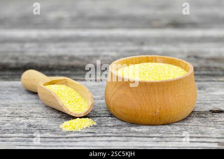 Cornmeal in wooden bowl Stock Photo