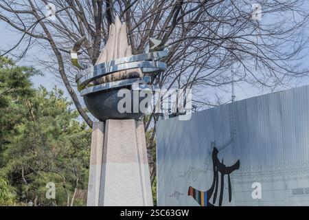 Seoul, South Korea, March 18, 2017:Abstract art made of concrete and metal on a concrete pillar next to a white wall with abstract figures n downtown Stock Photo