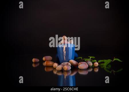hazelnuts with nutcracker isolated on black background. Stock Photo
