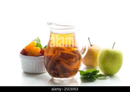 Traditional fruit drink on a wooden table, isolated on white background. Stock Photo
