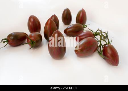 Pile of fresh ripe sweet red striped tomatoes isolated on white background.Rare tomato varieties on a white background are already on your banner. Stock Photo