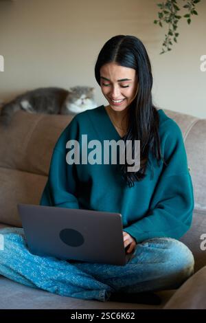 Smiling freelancer working from home with pet cat Stock Photo