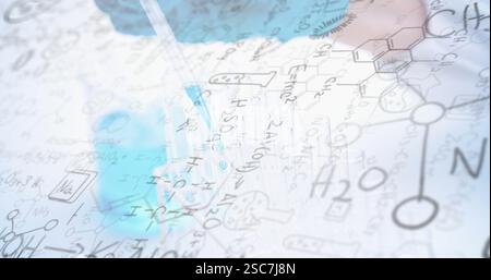 Chemical formulas and equations image over scientist using pipette in laboratory Stock Photo