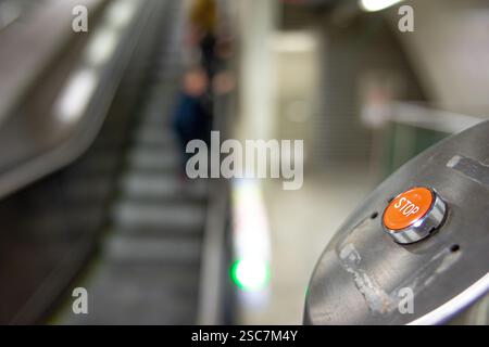 On the right side of the escalator emergency stop button on the left defocused Stock Photo