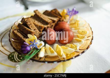 Traditional Easter breakfast food in Lithuania. Lithuanians also include a variety of cold dishes, freshly baked bread, boiled painted eggs, hams, sau Stock Photo