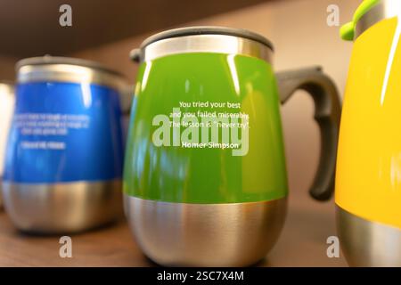 Hong Kong, China - February 05, 2015: a close-up shot of thermos mugs, each featuring a single quote, displayed on a shelf inside Pacific Coffee Compa Stock Photo
