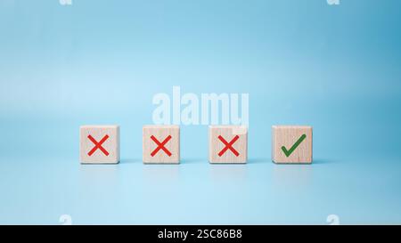Checkbox with green check mark from row of multiple boxes with red crosses on blue background, Pro and contra or accept and decline, Strategy of choic Stock Photo