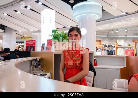 Bangkok, Thailand - January 24, 2020: a female staff member at a customer service counter at CentralWorld shopping mall. Stock Photo