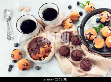 Muffins assortment on light background. Freshly baked cupcakes. Celebration concept. Top view, flat lay Stock Photo