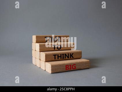Time to think big symbol. Wooden blocks with words Time to think big. Beautiful grey background. Business and Time to think big concept. Copy space. Stock Photo