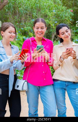 Happy Young Women Using Smartphones Outdoors.Vertical Stock Photo