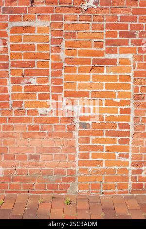 Reddish brick wall with the outline of a bricked-up window and a bricked-up door, bricks, background, Germany, Europe Stock Photo