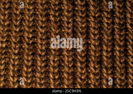 Detail of the cotton and polyester fabric of a golden vertical patterned sweater. Stock Photo