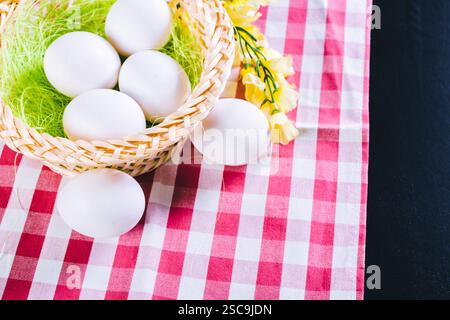 Eggs on tablecloth over black background Stock Photo