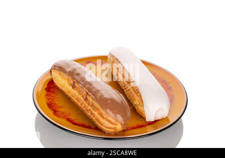 Two eclairs with cream filling on a ceramic saucer, close-up, isolated on a white background. Stock Photo