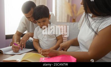Family drawing together in a cozy living room with a man helping a child and woman assisting, showcasing love and bonding in a home setting. Stock Photo