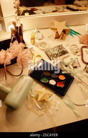 Various makeup brushes, tools, paints, and accessories arranged on a vanity table, ready for use in artistic projects or personal grooming Stock Photo