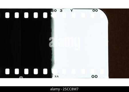 An empty vintage film negative, showing the beginning of the roll and a light-exposed section before the first exposure. Stock Photo