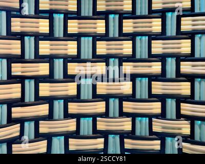 Close up of synthetic rattan or wicker weaving art in various pattern, blue, black, and white color. Rattan hand woven background seamless texture. Stock Photo