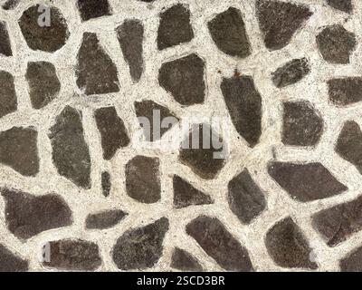 Natural flagstone or flattened flag stones, a series of cobble stone but flattened and paved seamlessly, for floor or wall finishes. Stock Photo