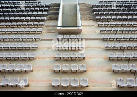 rows of plastic stadium grandstand seats, from above, empty Stock Photo
