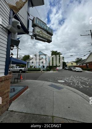 Street view of Liuzza's by the Track in New Orleans, known for its local cuisine, under a vibrant sign and blue skies. Stock Photo