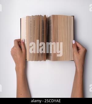 a book opened in a woman's hands Stock Photo