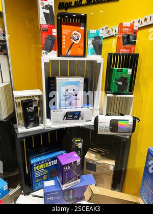 Kyiv, Ukraine - February 05, 2025: Various contemporary tech products, including power banks and controllers, beautifully arranged on shelves Stock Photo