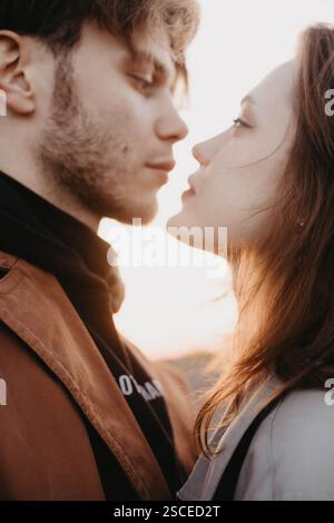 Romantic moment between a couple gazing at each other during a sunset Stock Photo