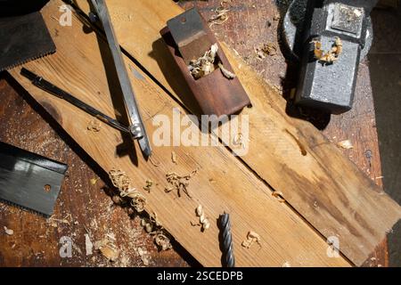 Old planer and other vintage carpenter tools in a carpentry workshop Stock Photo