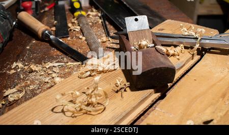 Old planer and other vintage carpenter tools in a carpentry workshop Stock Photo