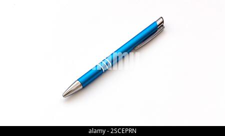 Blue ball point pen retracted on white bacckground with copy space Stock Photo