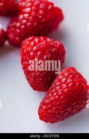 close up of red raspberries on white plate Stock Photo