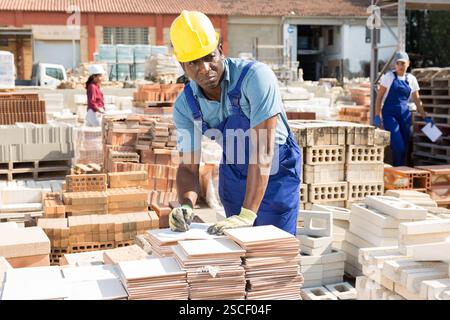 Builder is choosing ceramic tiles in building store Stock Photo