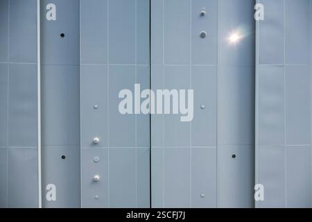 The background is a metal perforated structure, industrial minimalism. Stock Photo