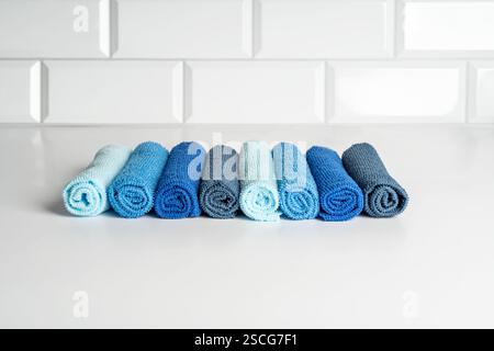 Colorful microfiber towels on a white table. Cleaning and housekeeping concept Stock Photo