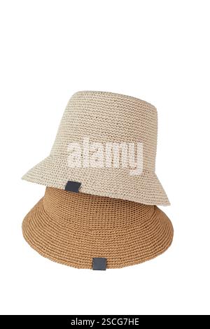 Beige and brown isolated hats lying one on another on a white background. Hats mockup, no brand, front view presentation Stock Photo