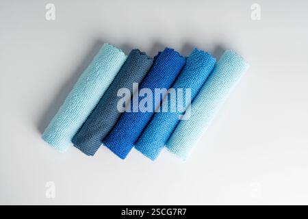 Colorful microfiber towels on a white table. Cleaning and housekeeping concept Stock Photo