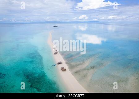 Aerial view of traditional wooden houses nestled on a lush green ...